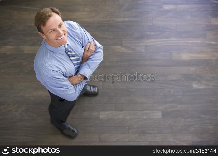 Businessman standing indoors smiling