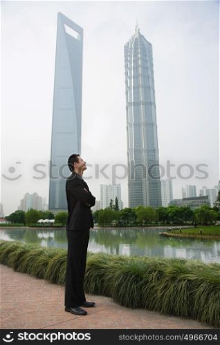 Businessman standing near skyscrapers