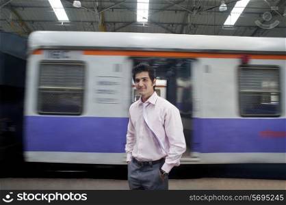 Businessman standing next to a train compartment
