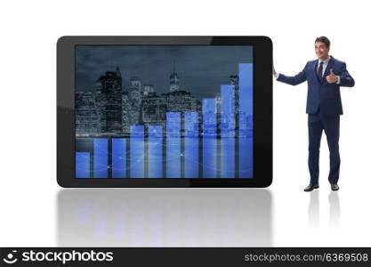 Businessman standing next to tablet computer on white background