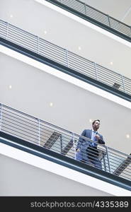 Businessman standing on balcony