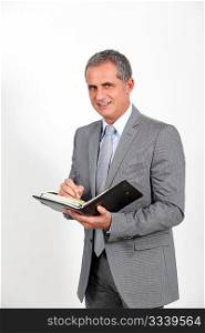 Businessman standing on white background with agenda