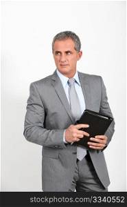 Businessman standing on white background with agenda