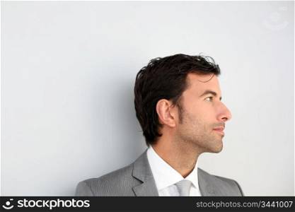 Businessman standing on white wall