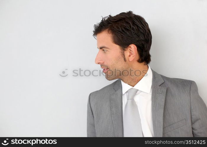 Businessman standing on white wall