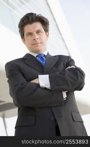 Businessman standing outdoors by building