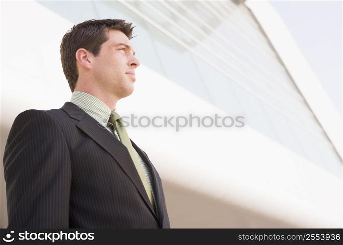 Businessman standing outdoors by building