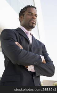 Businessman standing outdoors by building