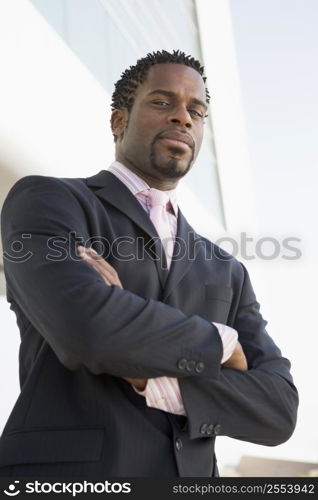 Businessman standing outdoors by building