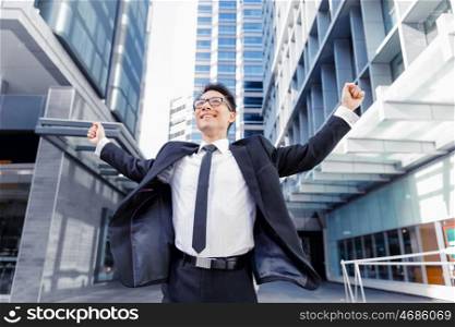 Businessman standing outdoors in city business district. Aimed to success in business