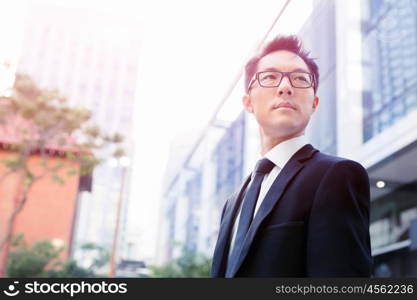 Businessman standing outdoors in city business district. Serious about my business