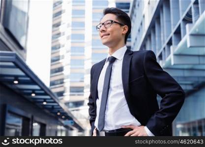 Businessman standing outdoors in city business district. Serious about my business
