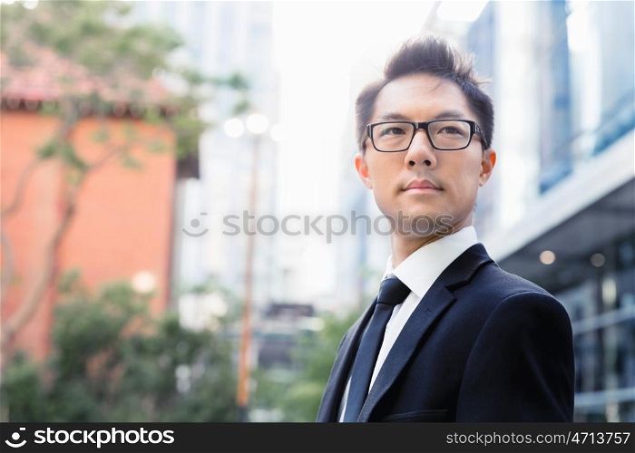 Businessman standing outdoors in city business district. Serious about my business