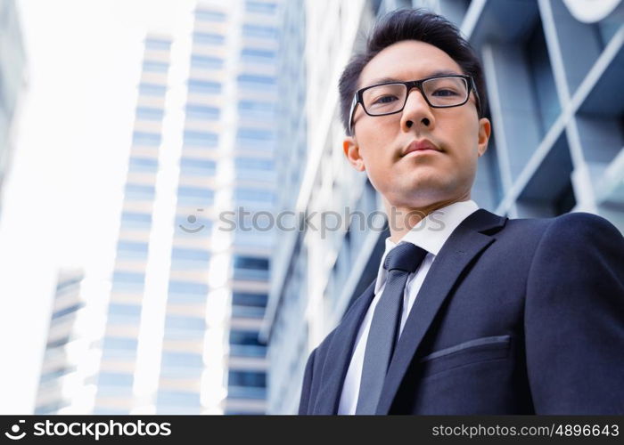 Businessman standing outdoors in city business district. Serious about my business