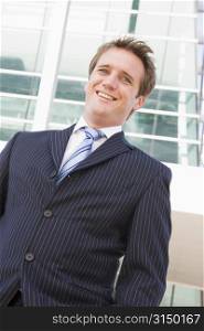 Businessman standing outdoors smiling