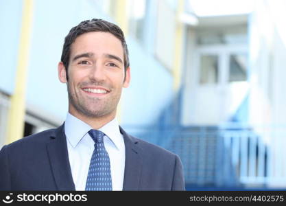 Businessman standing outside a building