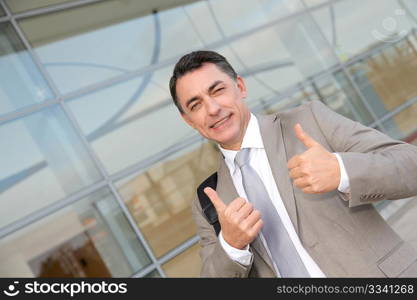 Businessman standing outside modern building