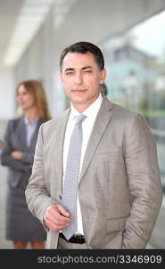 Businessman standing outside modern building