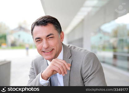 Businessman standing outside modern building