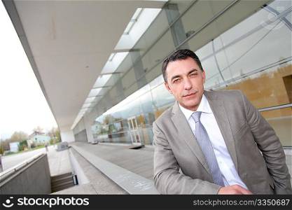 Businessman standing outside modern building