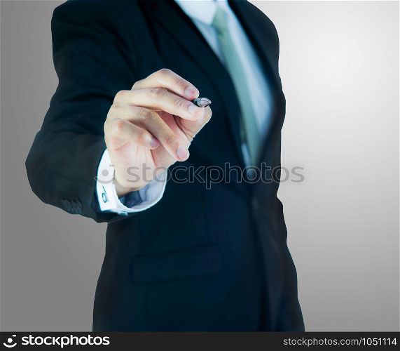 Businessman standing posture hand hold a pen isolated on over gray background