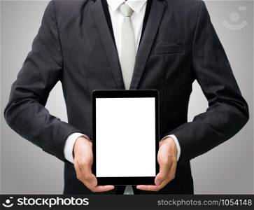 Businessman standing posture hand holding blank tablet isolated on over gray background