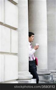 Businessman Standing with a Cup of Coffee
