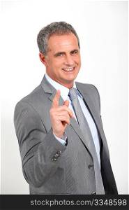 Businessman standing with finger pointed at camera