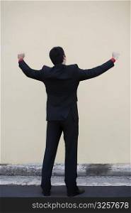 Businessman standing with his arm outstretched