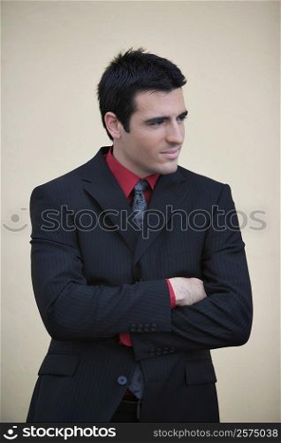 Businessman standing with his arms crossed and smiling
