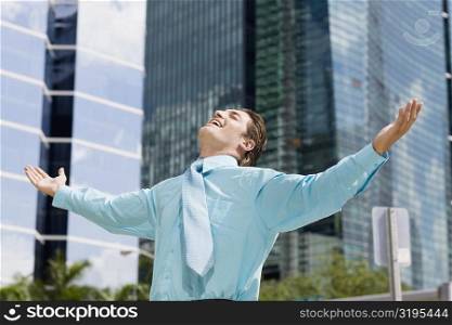 Businessman standing with his arms outstretched