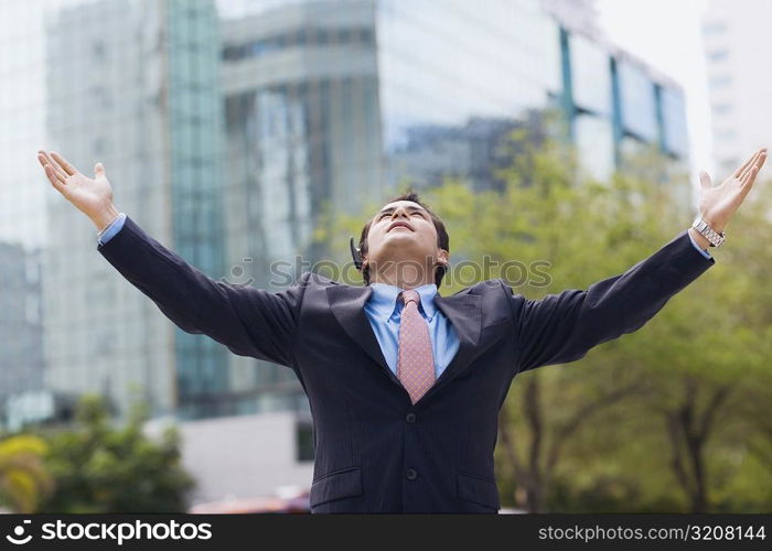 Businessman standing with his arms outstretched