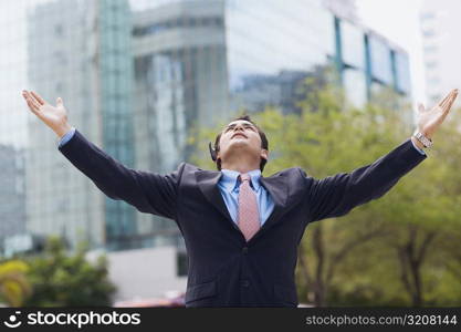 Businessman standing with his arms outstretched