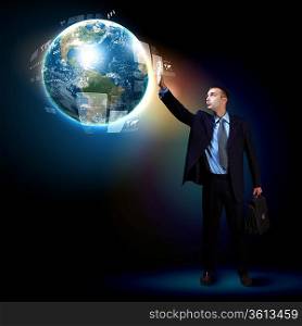Businessman standing with modern technology symbols next to him. Elements of this image are furnished by NASA