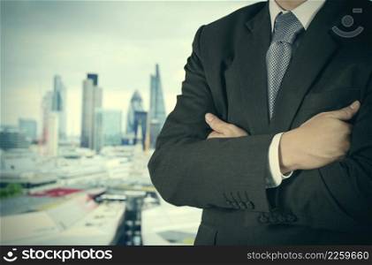 businessman stands successfully on building top thinking Towards the future with london city blurred background