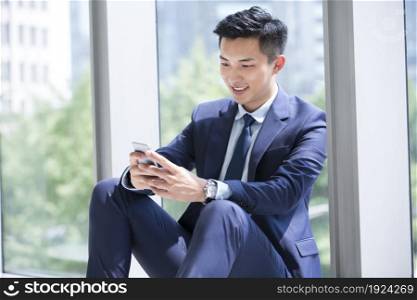 Businessman staring at his mobile phone