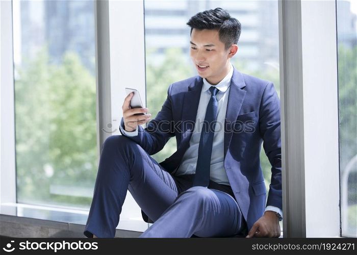 Businessman staring at his mobile phone