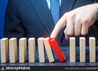 Businessman starts the process of falling dominoes. Correction of errors malfunctions. Implementation of plans. Starting work after stopping. Continuation working, obstacle avoidance. Maintainability.