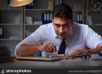 Businessman staying late in office for drugs