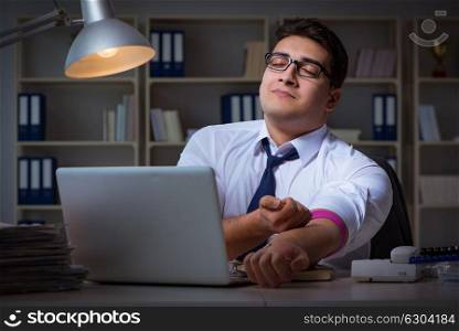 Businessman staying late in office for drugs