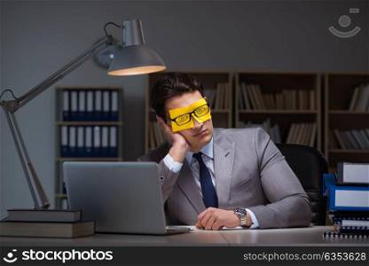 Businessman staying late to sort out priorities