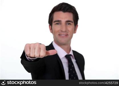 Businessman sticking out his thumb