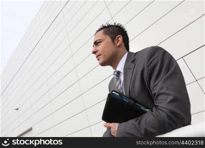 Businessman stood holding diary