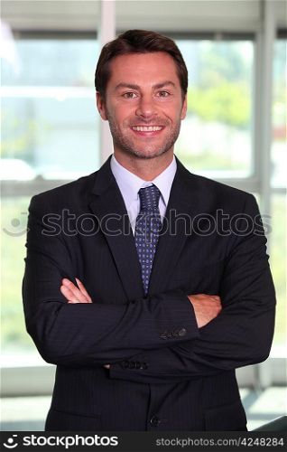 Businessman stood with arms crossed
