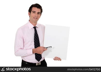 Businessman stood with blank poster