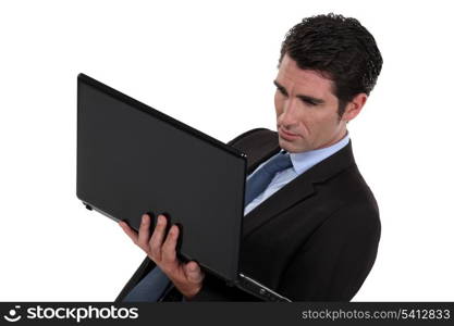 Businessman stood with laptop