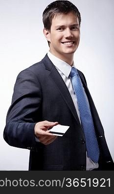 Businessman stretching a credit card isolated