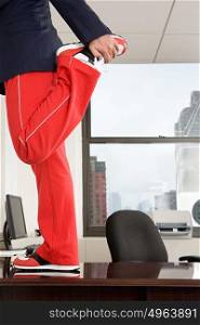 Businessman stretching on desk
