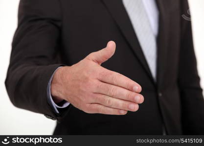 businessman stretching out hand to shake hands