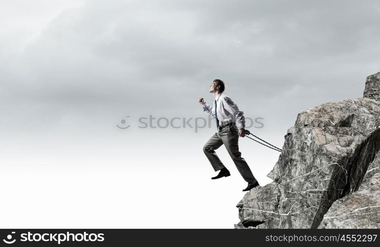 Businessman struggling with problems that occur on the way. Bound with responsibility